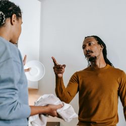 black man threatening unrecognizable girlfriend during quarrel at home