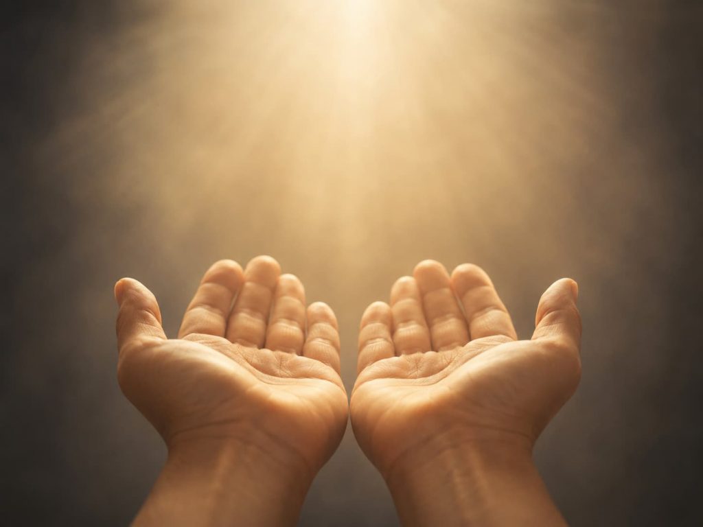 pair of open hands held upward in a posture of receiving, warm light falling on them, representing the posture of openness that healing attachment to God requires