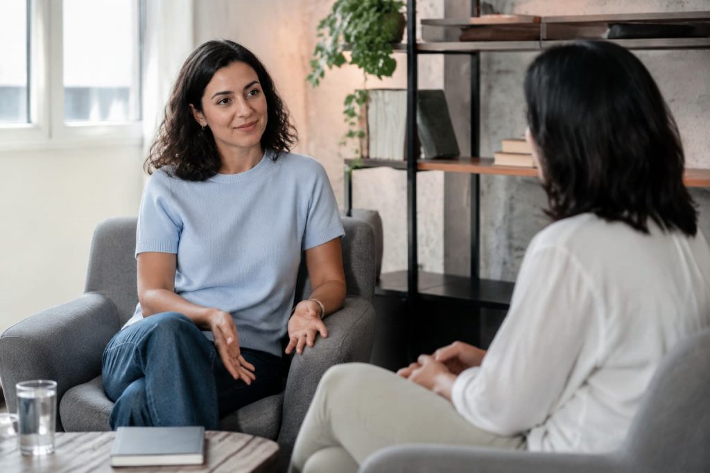 Person in a supportive counseling conversation, receiving Christian therapy for anxiety